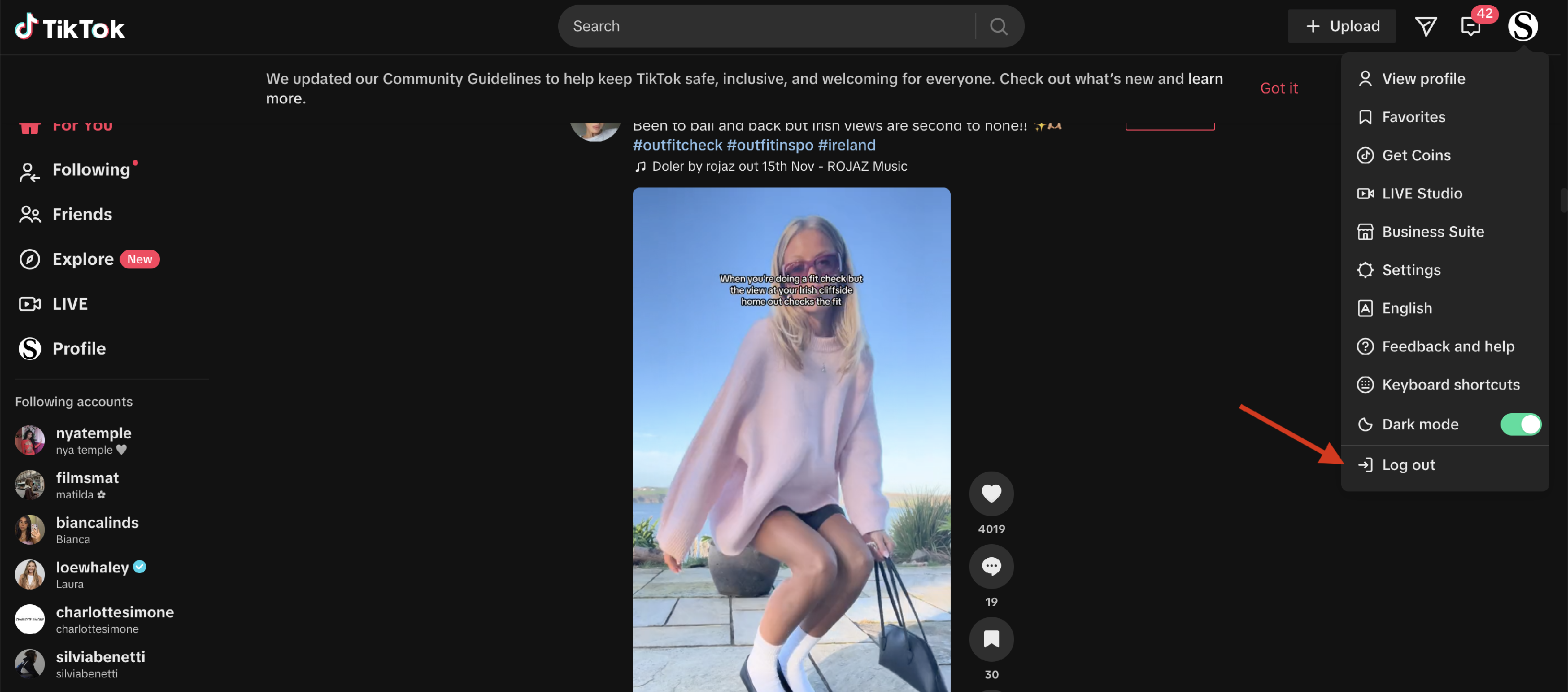 TikTok website with the profile menu open and Log out highlighted.